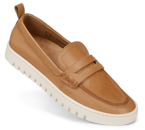 A tan loafer with a white textured sole and a pull tab at the heel.