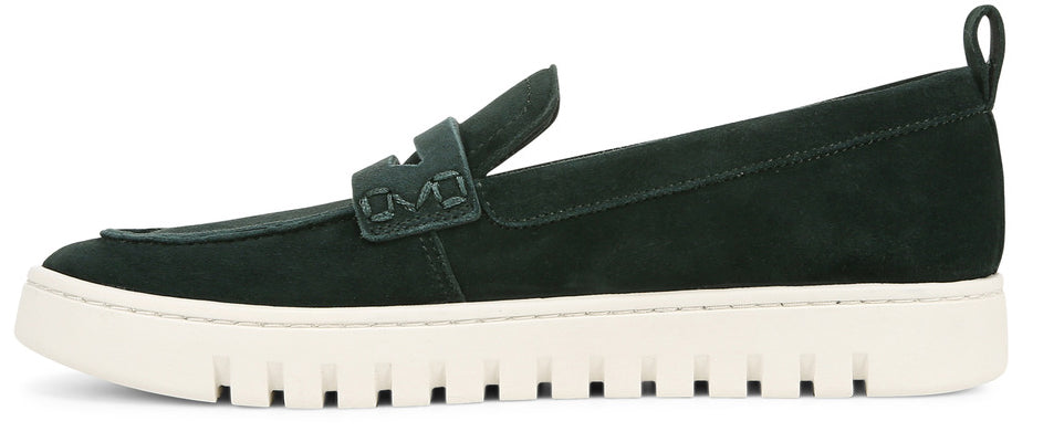 Green suede slip-on shoe with a white sole and a decorative strap across the vamp.
