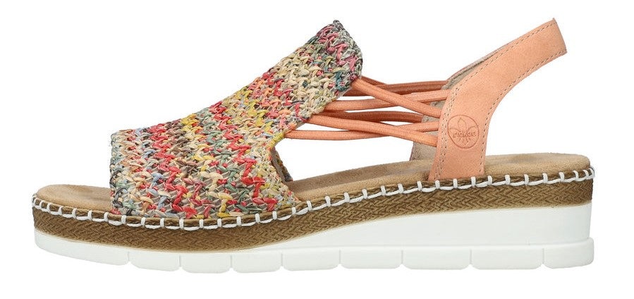 A multicolored woven sandal with a tan heel strap and a thick white sole.