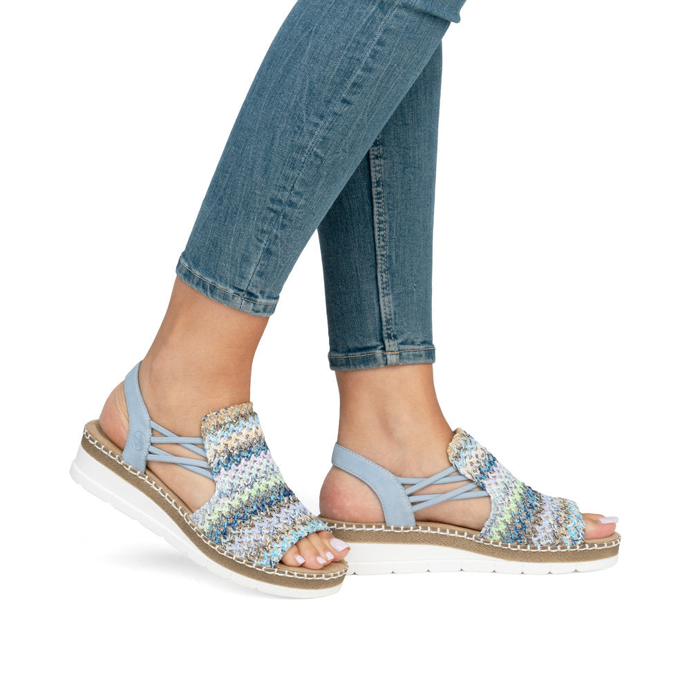 Light blue woven sandals with elastic straps on a white and brown platform sole. 