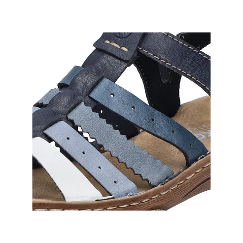 Close-up of blue and white leather sandal with woven straps and velcro closure.
