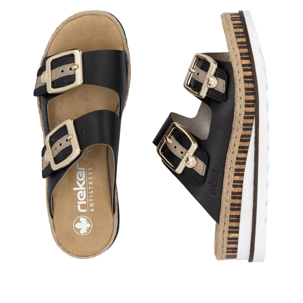 Two black slide sandals, each with two adjustable gold-buckled straps and thick, layered soles. One sandal is top-down view, and the other sandal is side view.
