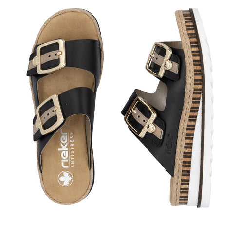 Two black slide sandals, each with two adjustable gold-buckled straps and thick, layered soles. One sandal is top-down view, and the other sandal is side view.