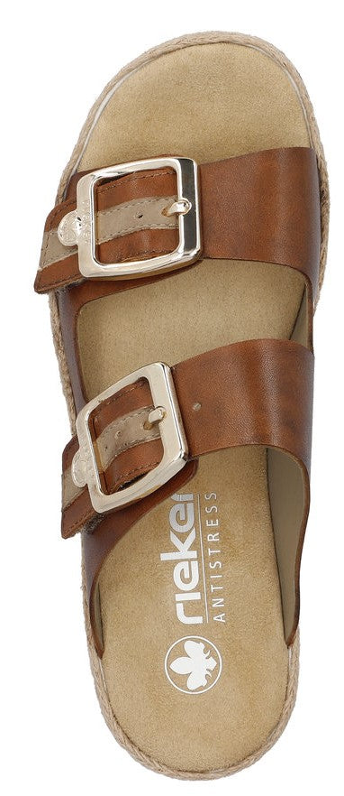 A pair of brown sandals with silver buckles.