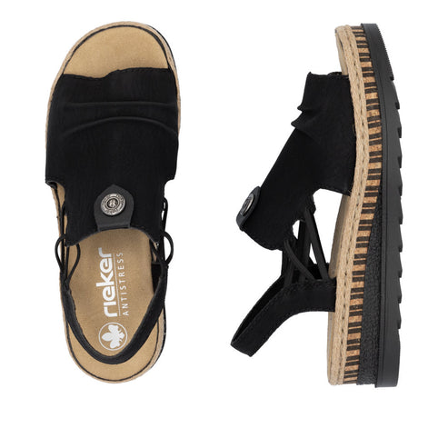 Two black rieker brand sandals with visible decorative buttons and rubber and faux wood soles.