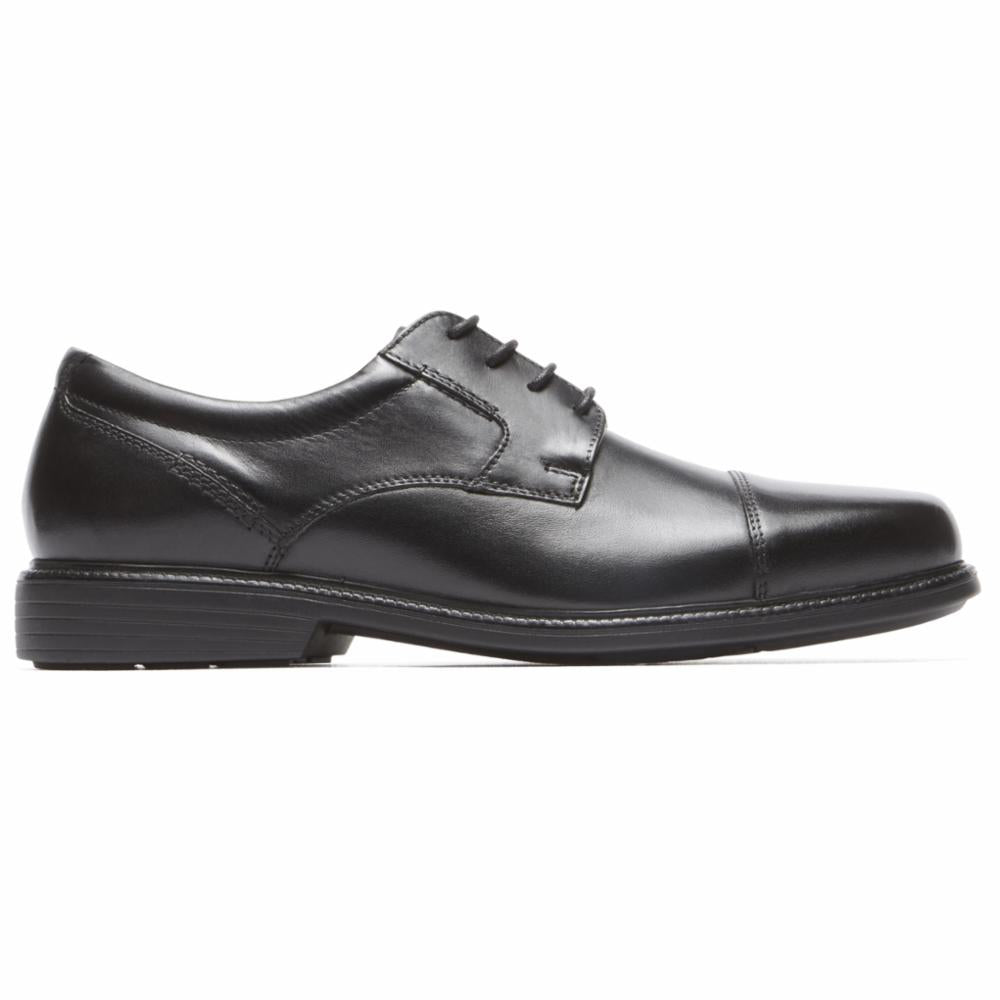 Black cap-toe dress shoe with black laces and a low heel.