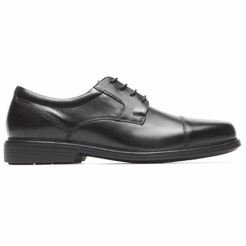 Black cap-toe dress shoe with black laces and a low heel.