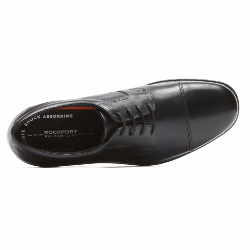 Black cap-toe dress shoe with visible Rockport branding on insole.