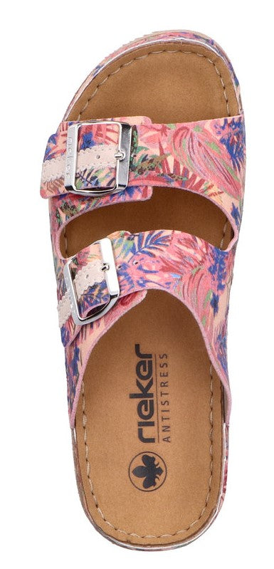 a pair of floral slide sandals with silver buckles