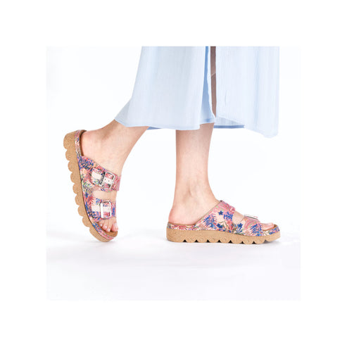 Floral patterned double-strap sandals with a light brown sole on a person's feet.