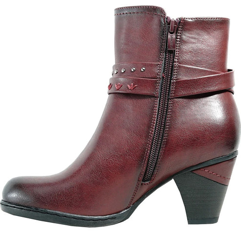 A maroon ankle boot with a block heel, a side zipper, and a decorative strap featuring small silver studs and embroidered details around the ankle.