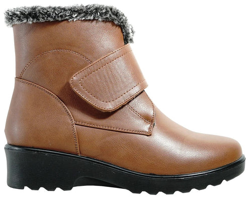 A tan brown ankle boot with a black textured sole and a faux fur collar, featuring a diagonal velcro closure strap.