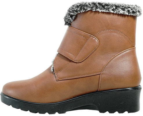 A tan-colored faux leather ankle boot featuring a thick, black rubber sole with a rugged tread pattern and a soft gray and white faux fur trim around the collar, secured by a single velcro strap across the upper.
