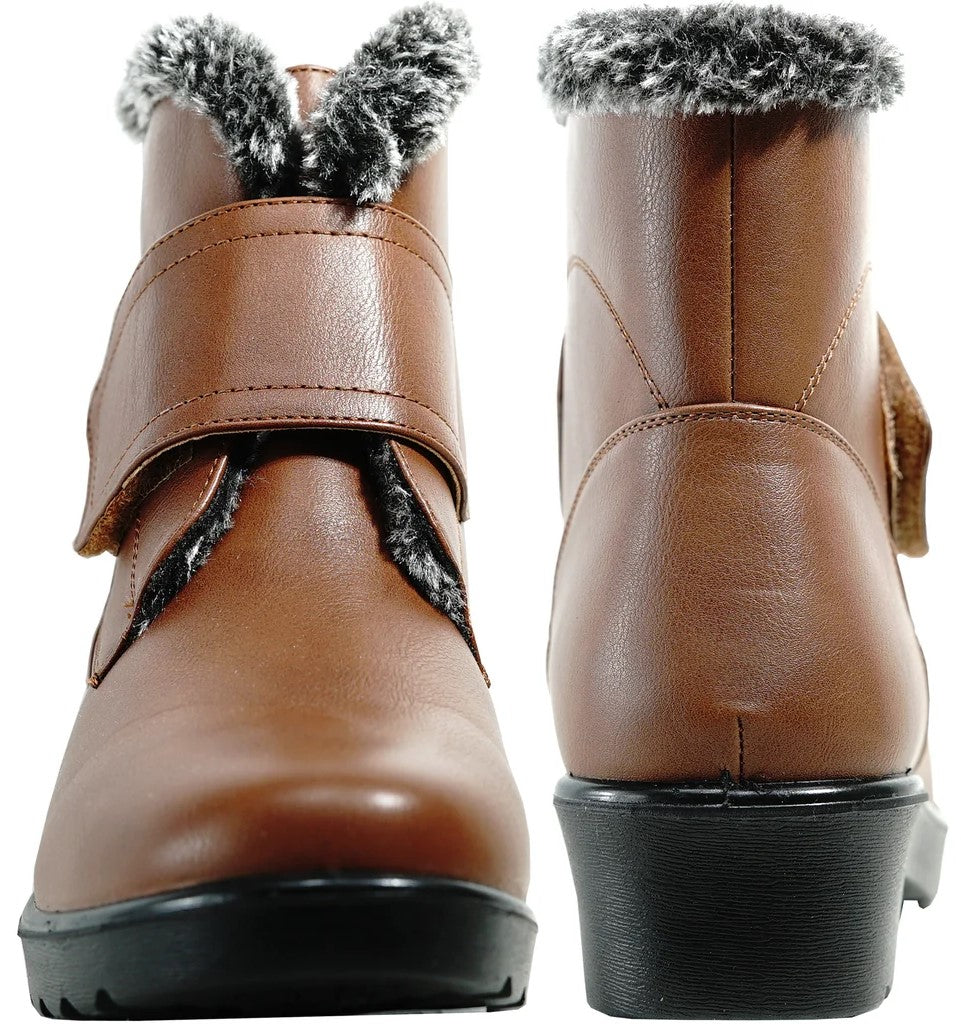 A pair of tan, faux leather ankle boots with black rubber soles, featuring a wide hook-and-loop closure strap across the front, gray faux fur trim around the collar, and a view showing both the front and the back of the boots.