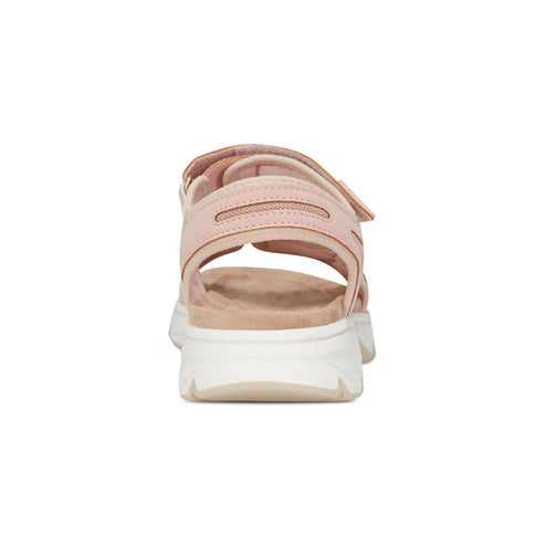 Pink sandal with white soles and velcro straps.