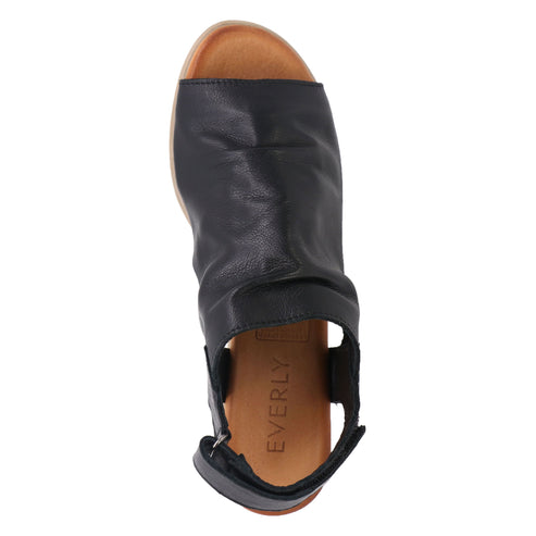 Black leather peep-toe sandal with an ankle strap and the text EVERLY visible on the heel.