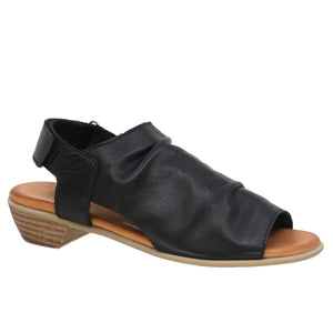 Black leather sandal with a low heel and a hook-and-loop closure strap.