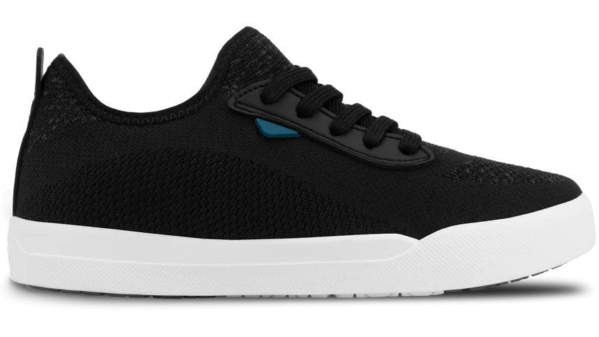 A black knitted sneaker with a white rubber midsole and black laces, featuring a small teal accent near the eyelet.