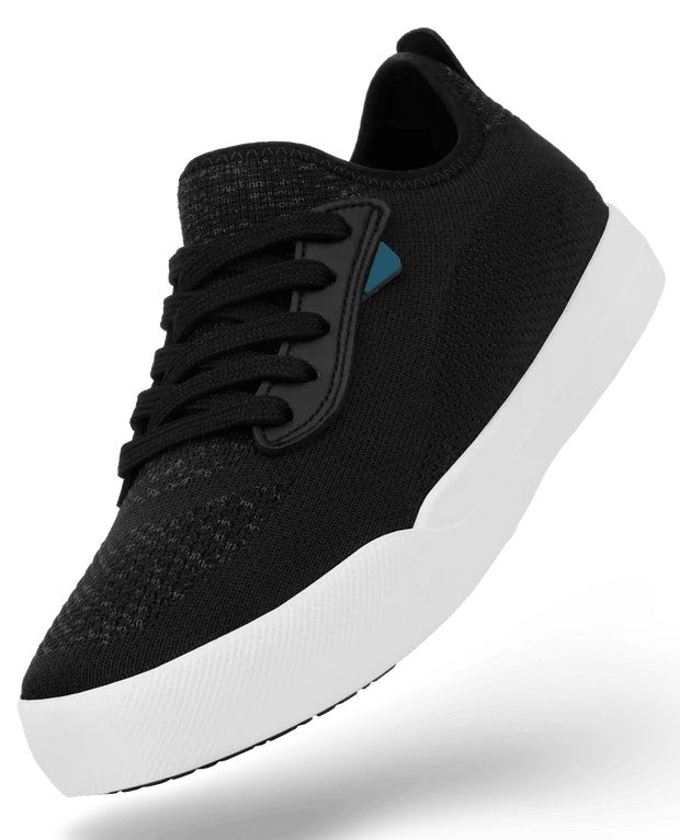 A black knitted sneaker with a thick, white rubber sole and black laces, shown at an angle against a plain background.