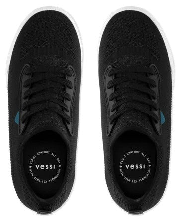 A top-down view of a pair of black sneakers with white soles, black laces, and the text "vessi CLOUD COMFORT ALL DAY WITH DYNA-TEX TECHNOLOGY" printed on the insoles.