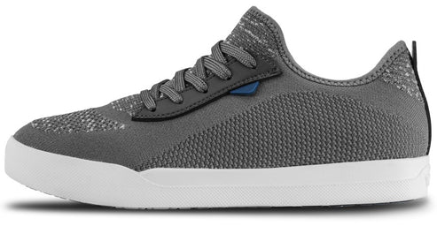 A gray low-top knit sneaker with a white rubber midsole, gray laces, and a small blue accent piece near the lace eyelets.
