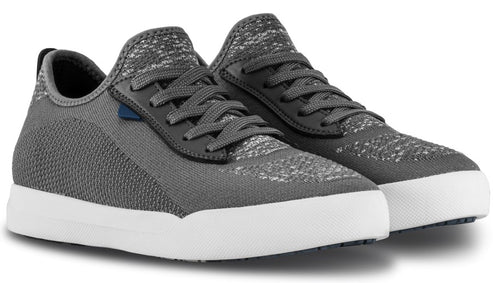 A pair of grey, low-top knit sneakers with white rubber soles and dark grey laces.