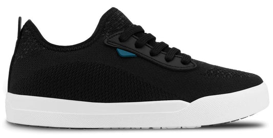 A black knitted sneaker with a thick white rubber sole, black laces, and a small blue accent piece near the eyelets.