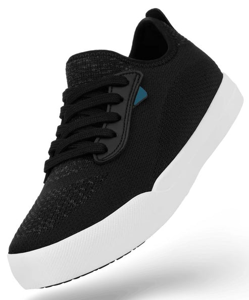 A black knitted sneaker with black laces and a thick white sole, angled slightly upward against a white background.
