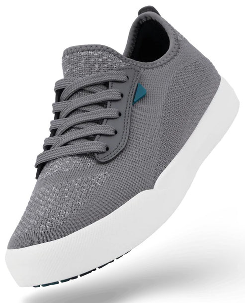 A gray low-top knit sneaker with a white rubber sole and gray laces, featuring a small teal accent near the eyelets.