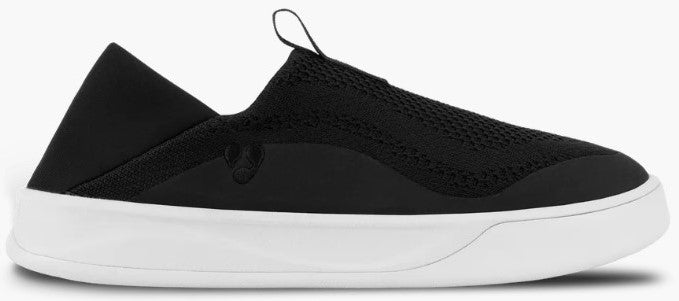 A black slip-on shoe with a breathable knit upper, a soft neoprene-like collar, and a thick white flat sole.