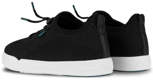 A pair of black knit sneakers with white soles, viewed from a side-rear angle, showing elastic laces and a black heel pull tab.