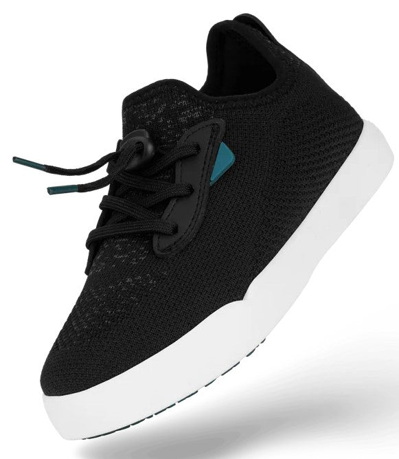 A black knit sneaker with a white rubber sole and a black toggle lacing system, featuring a small blue accent tag on the side.