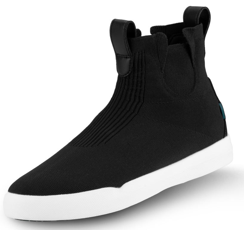A black slip-on ankle boot with a textured, ribbed fabric upper, black leather-like pull tabs at the front and back of the collar, and a thick, smooth white rubber sole.