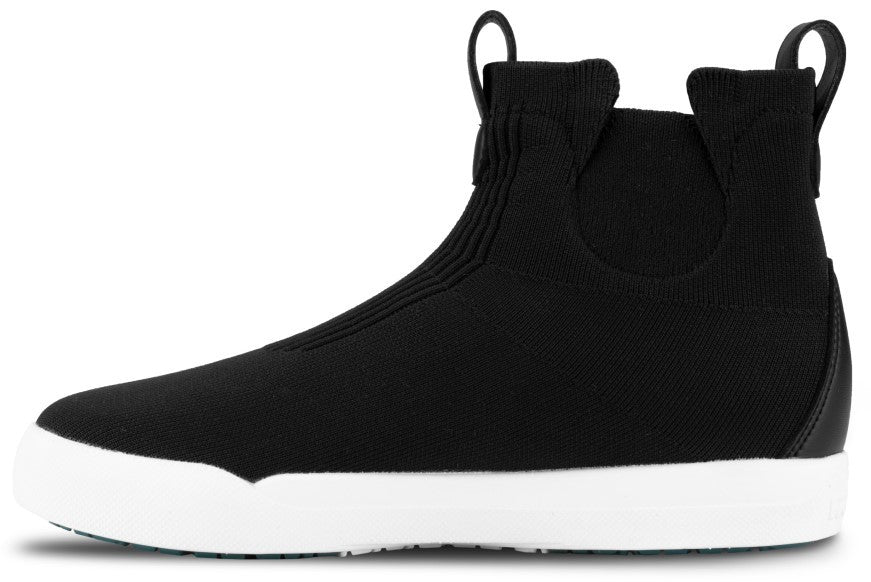 A black slip-on bootie with a sock-like knit upper, featuring a white rubber sole and two small pull tabs at the collar.