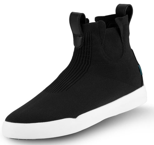 A black ankle-high sneaker boot with a ribbed fabric upper, a slip-on design with a pull tab at the back, and a thick, solid white rubber sole.