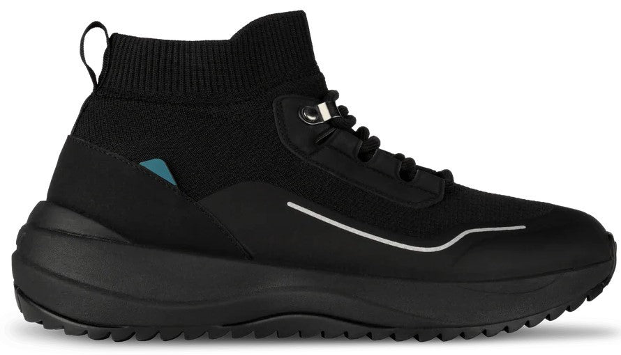 A black high-top sneaker with a knitted upper, a thick rubber sole with a treaded bottom, a small blue tag on the heel, and a reflective silver line detail.