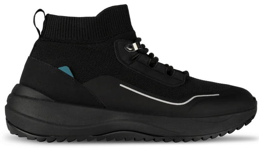 A black high-top sneaker with a knitted upper, a thick rubber sole with a treaded bottom, a small blue tag on the heel, and a reflective silver line detail.