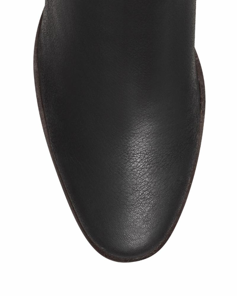 Close-up of the toe of a black leather boot with a rounded point.