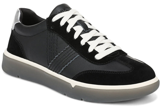 A low-top sneaker in black leather and suede, featuring a white lace-up closure, a silver heel accent, and a chunky translucent grey rubber outsole with a white midsole.
