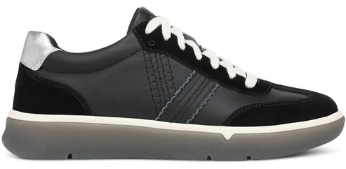 A low-top sneaker featuring a black leather and suede upper, white laces, a silver metallic heel patch, and a chunky, translucent grey rubber sole with a white midsole stripe.
