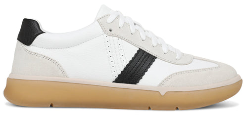 A white sneaker with a suede toe and heel cap, a black leather heel tab, white laces, and a prominent black, textured stripe running vertically along the side, set on a tan rubber gum sole.