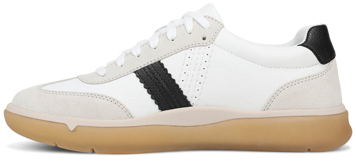 A low-top sneaker with a white leather upper, grey suede overlays on the toe and heel, a black serrated stripe along the side, and a gum rubber sole.