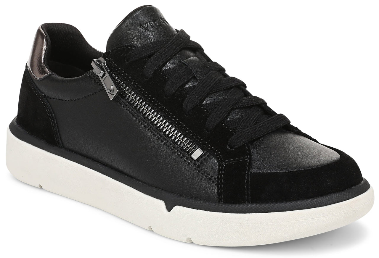 A black leather and suede lace-up sneaker with a side zipper, metallic heel detail, and a thick white rubber sole.