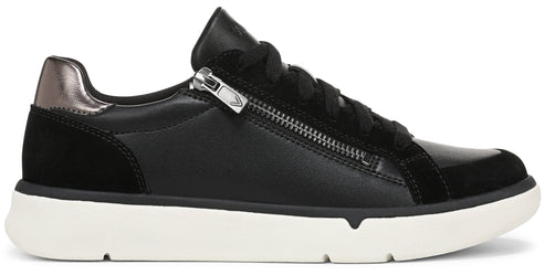 A black leather and suede casual sneaker with a white rubber sole, black laces, and a prominent silver zipper detail on the side near the collar, featuring a metallic bronze-toned heel patch.