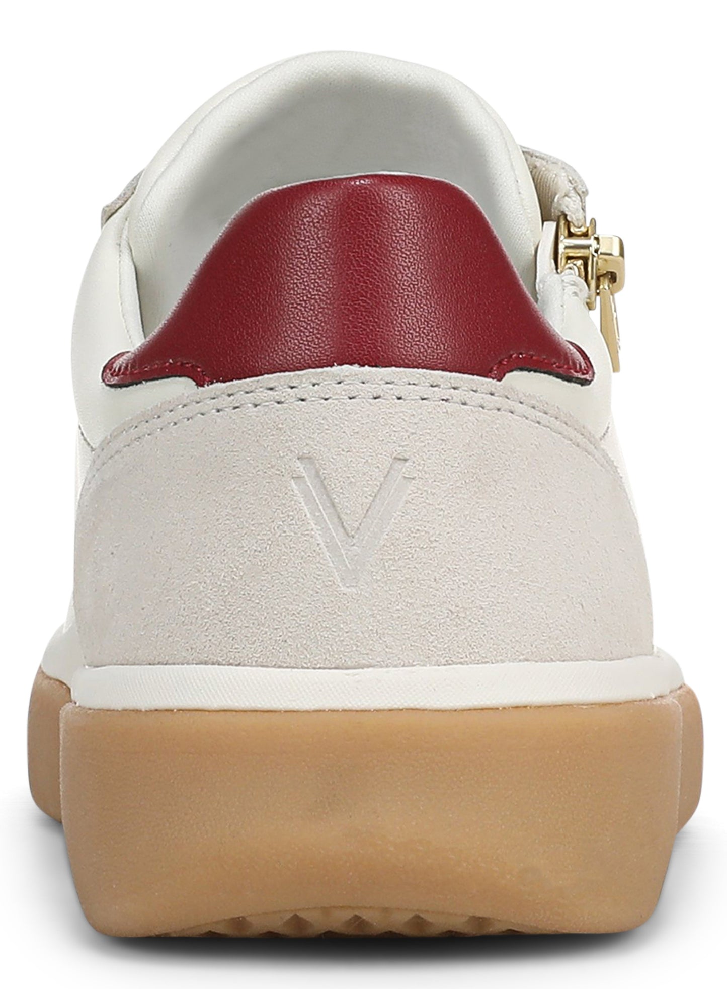 Rear view of a white sneaker with a red leather heel tab, a beige suede heel counter featuring an embossed V logo, and a gum-colored rubber sole.