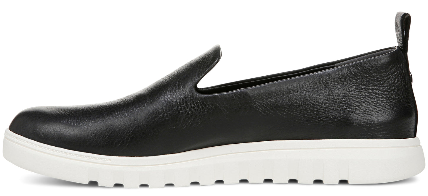 A black leather slip-on shoe with a white sole.