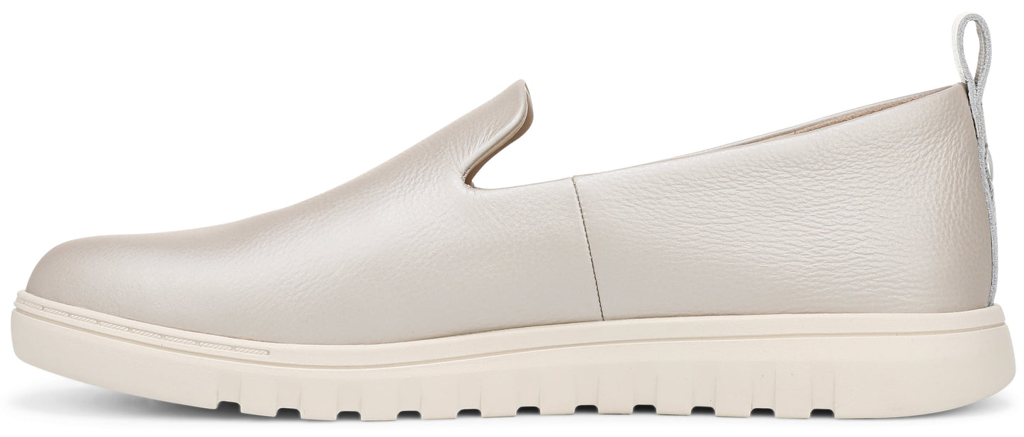 A slip-on shoe with a flat, light-colored sole and a silver upper.