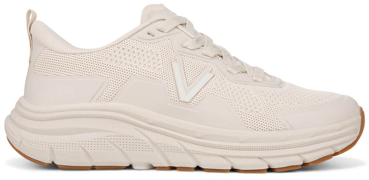 Beige athletic shoe with a thick sole and brown rubber bottom.