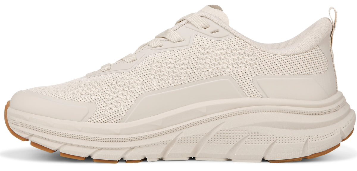 A beige athletic walking shoe with knit texture.