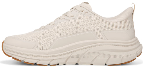 A beige athletic walking shoe with knit texture.